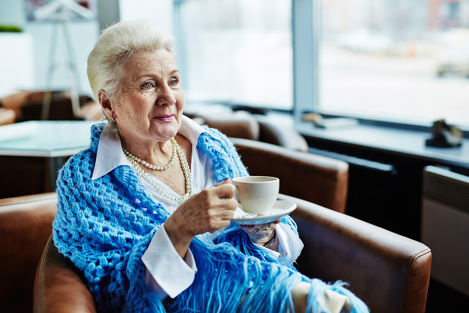 elder woman enjoying a nice warm cup of coffee